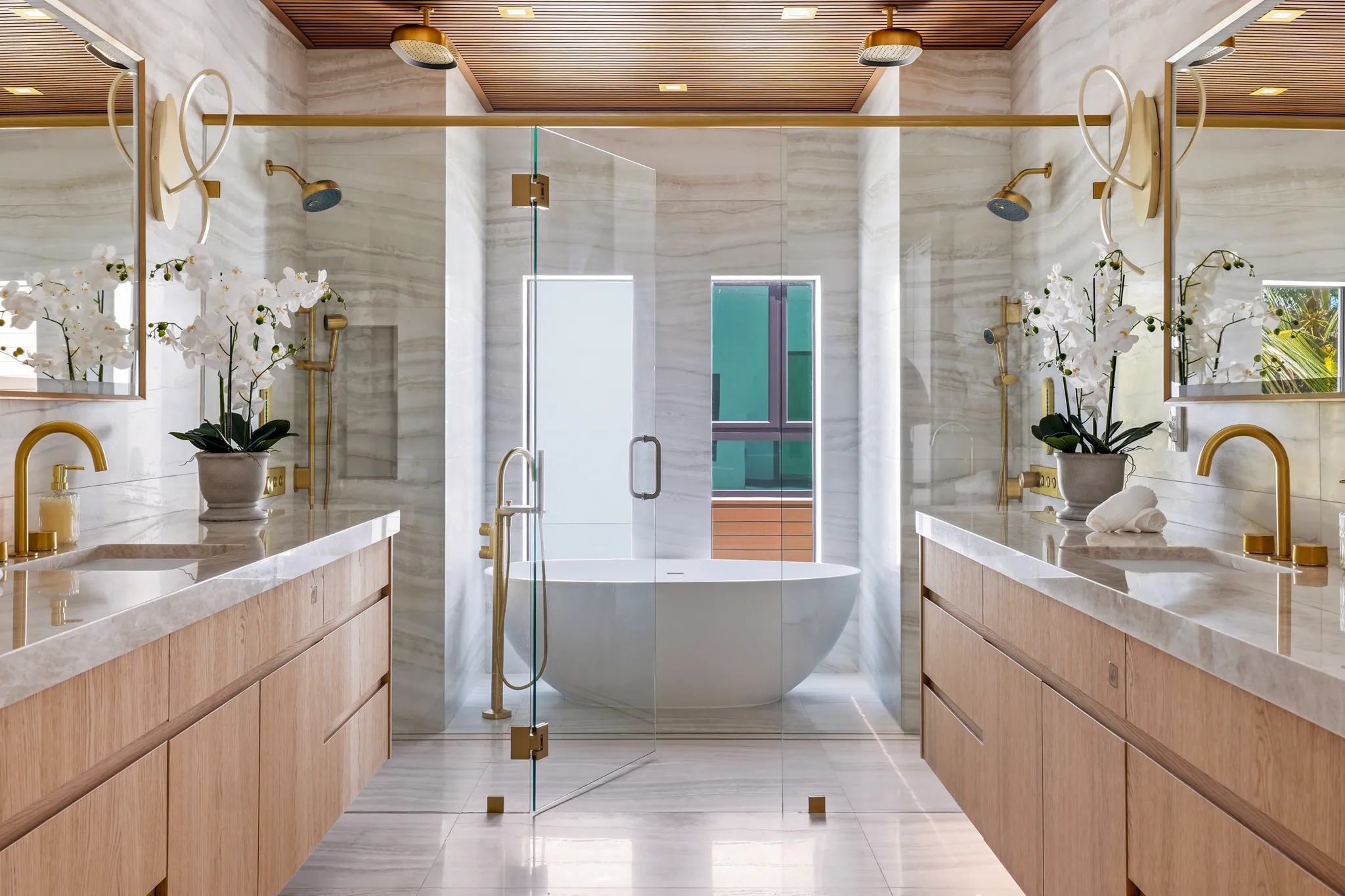 Primary bath wet zone with sculpted soaking tub between dual showers