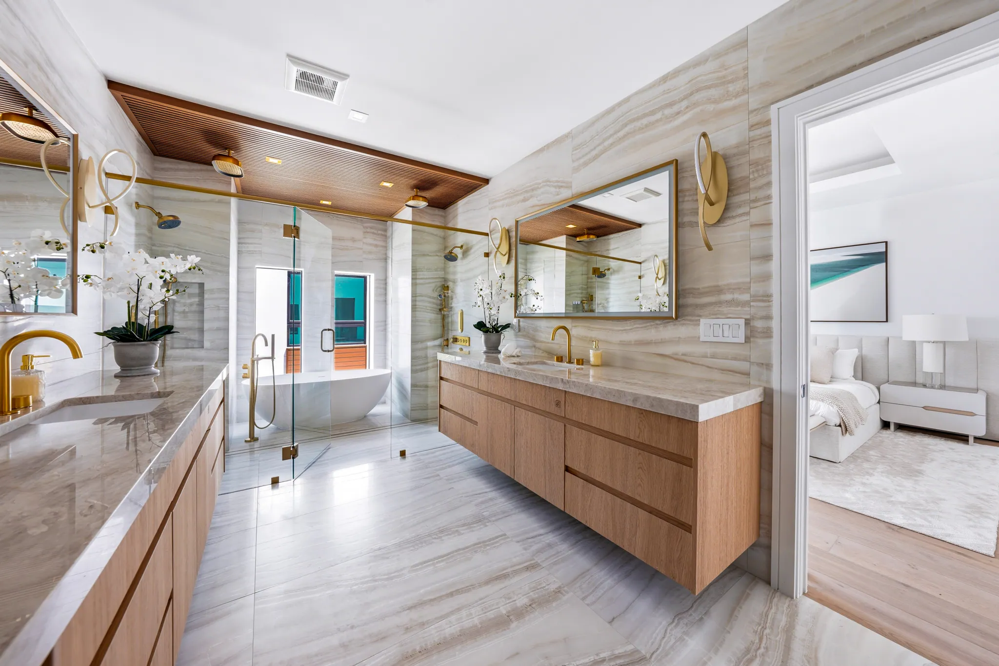 Primary bath floating vanity with view through to bedroom suite